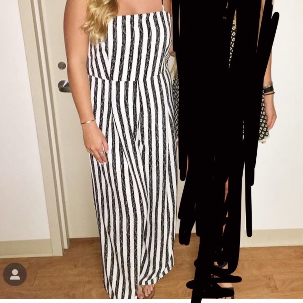Large Event black and white vertical striped jumpsuit.